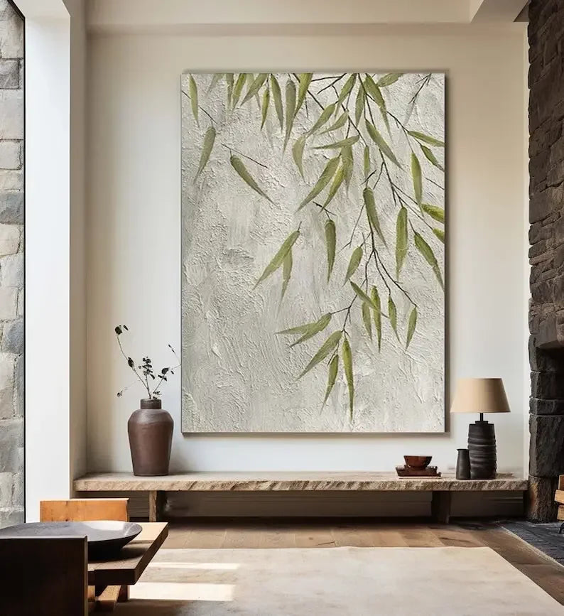 Decorative wall art with green leaves in a modern interior setting.