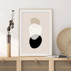 Framed abstract art print on a wall with decorative items.