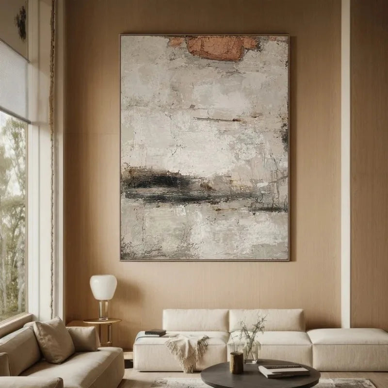 Modern living room with a large abstract painting on a beige wall.