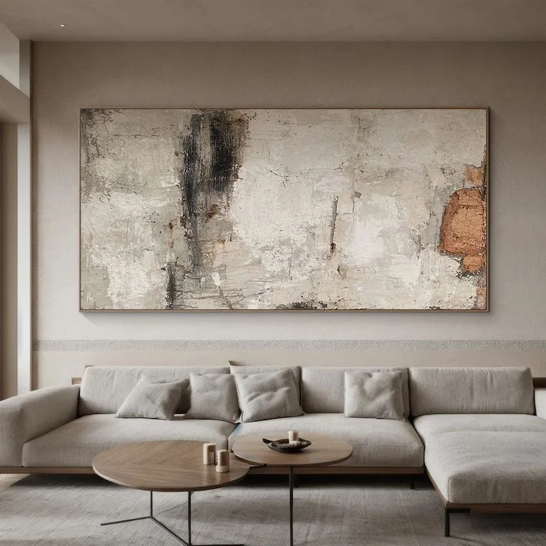 Modern living room with a large abstract painting above a sectional sofa.