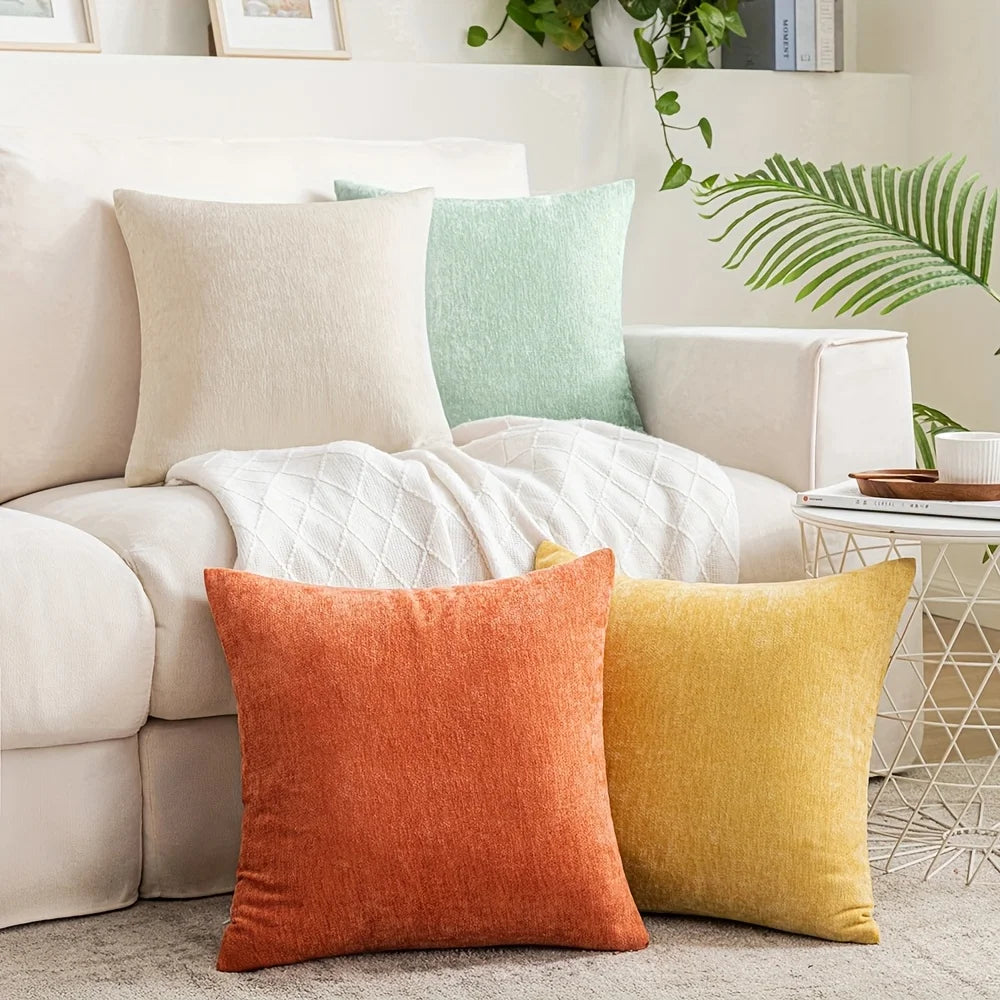 Colorful pillows on a beige sofa in a living room setting