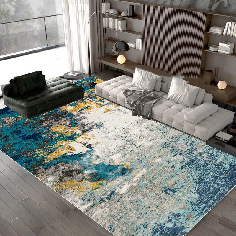 Modern living room with a colorful abstract rug, gray sofa, and bookshelf.