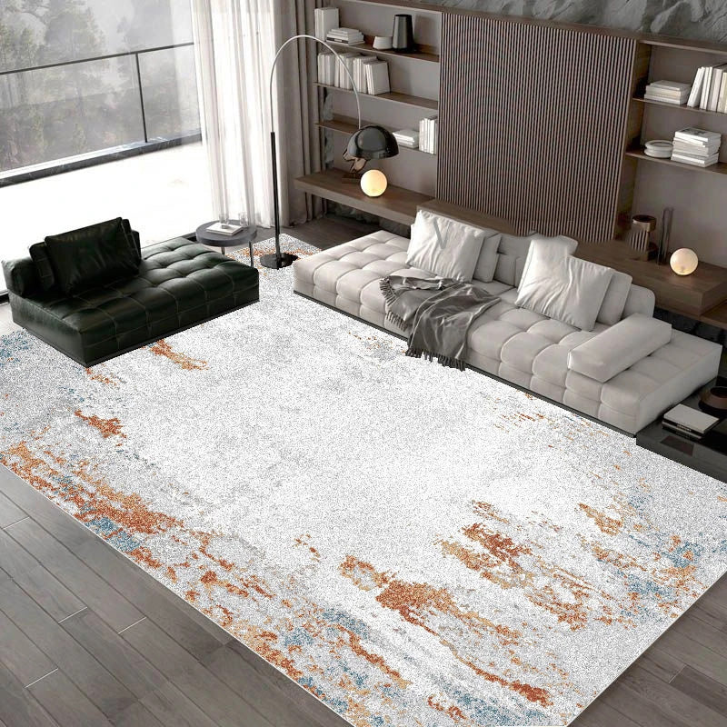 Modern living room with a patterned rug, gray sofa, and black armchair.