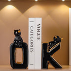 Black cat-shaped bottle and bookend with a Vogue magazine in the background