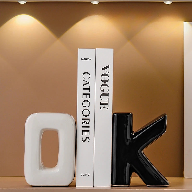 Decorative books with 'Vogue' and 'GUARO' branding on a shelf against a brown wall.