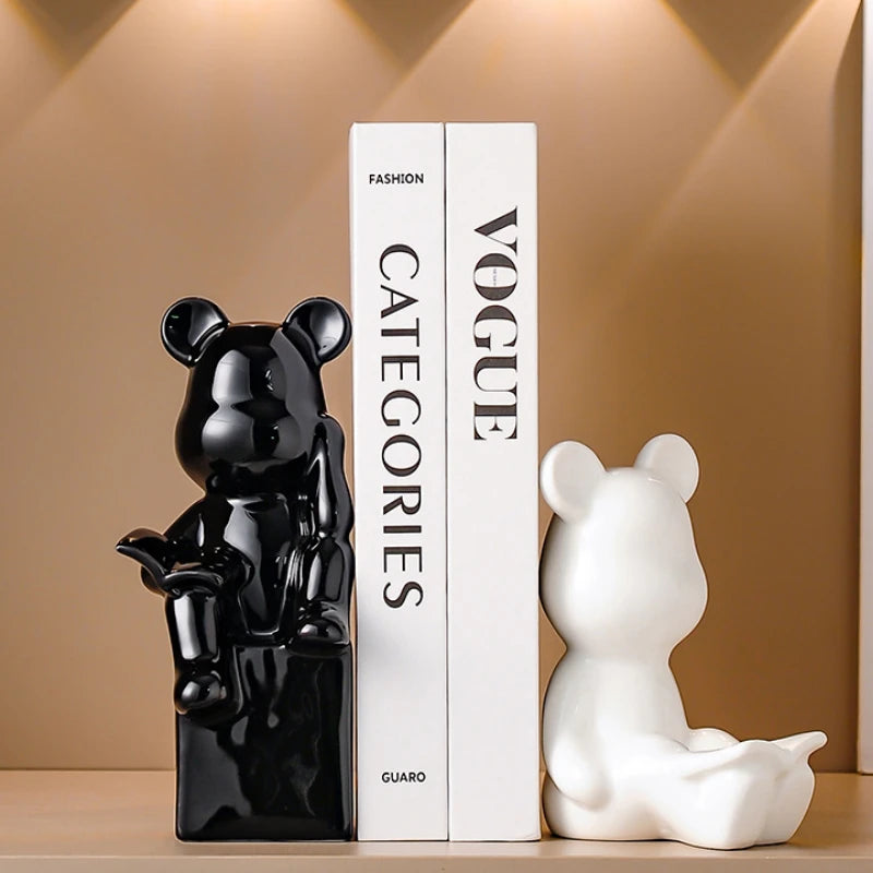 Black and white bear-shaped bookends on a shelf with a 'Vogue' magazine in the background.