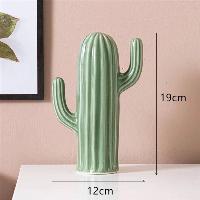 Green cactus-shaped vase with measurements on a pink background
