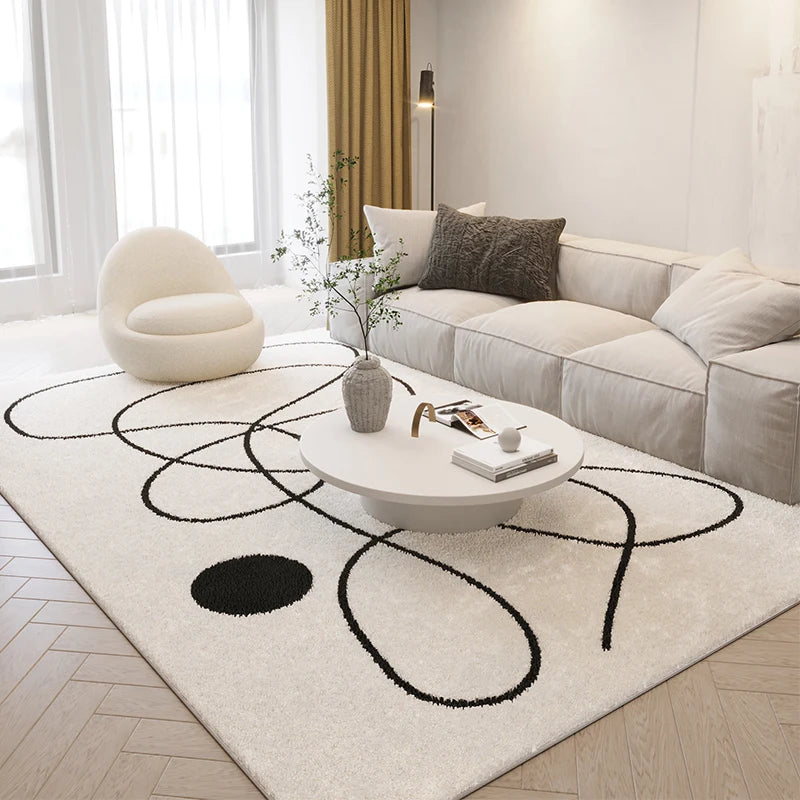 Modern living room with a white sofa, round coffee table, and decorative rug.