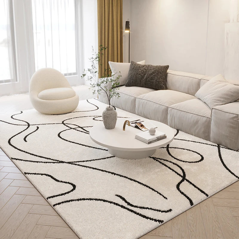 Modern living room with a white sofa, coffee table, and decorative rug.