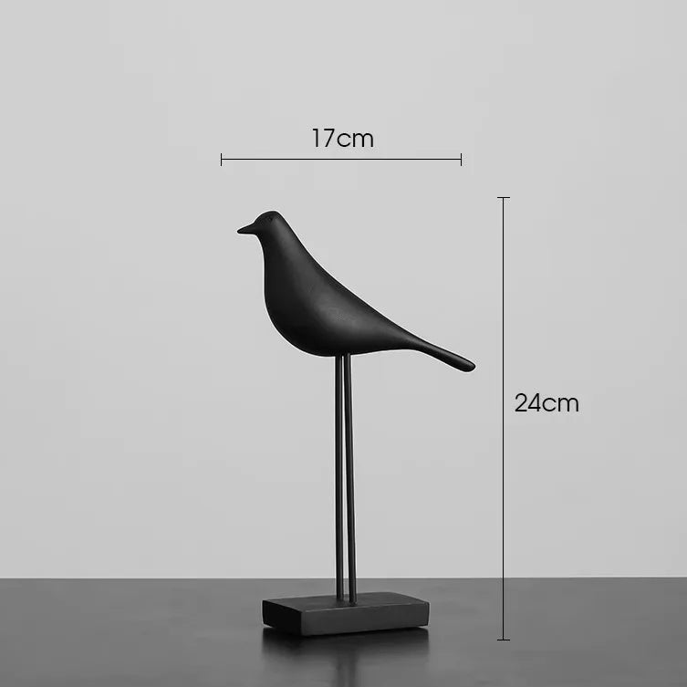 Black bird-shaped sculpture with measurements on a gray background