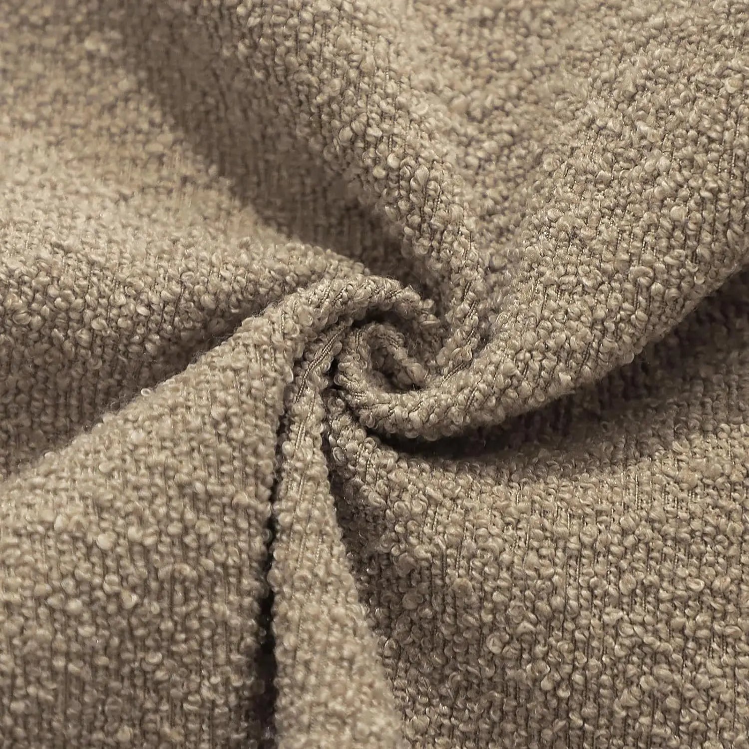 Close-up of textured beige fabric with a fold