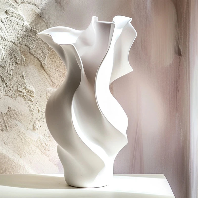 White wavy ceramic vase on a neutral background