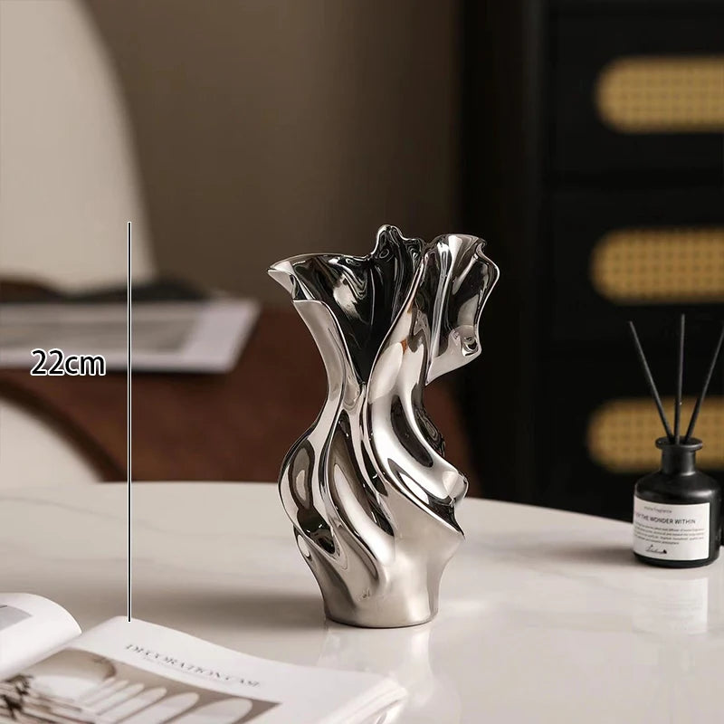 Silver decorative vase on a surface with a blurred background