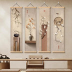 Four vertical wall hangings with floral and teapot designs on a neutral wall.