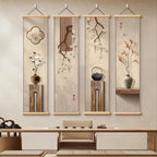 Four vertical wall art pieces with floral and teapot designs hanging above a wooden table.