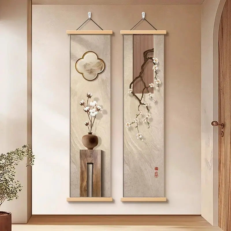 Two vertical wall art pieces with floral designs on a beige wall.
