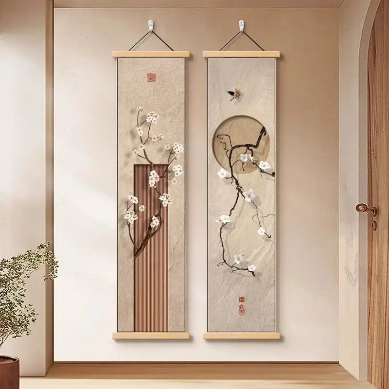 Two vertical wall scrolls with floral designs hanging on a beige wall.