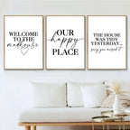 Three framed prints with humorous quotes on a wall above a sofa.
