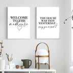 Two framed prints on a wall with decorative items below.