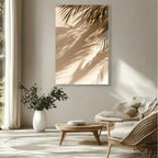 Modern living room with wicker chairs, wooden coffee table, and wall art of palm leaves.
