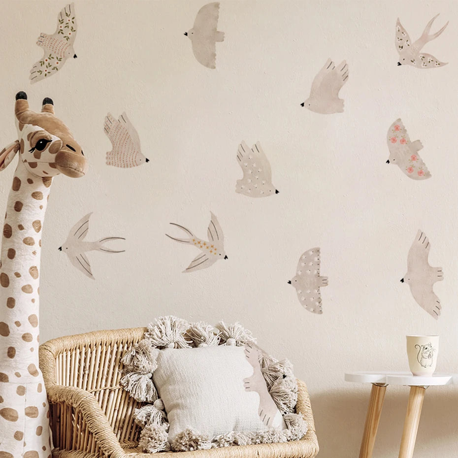 Children's room with a giraffe plush toy, wicker chair, and wall decals of animals.