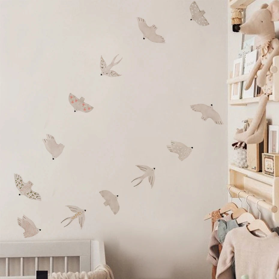 Children's room with wall decals of birds and a shelf with toys and books.