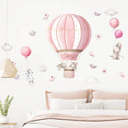Children's room with pink hot air balloon wall decal and decorative elements.