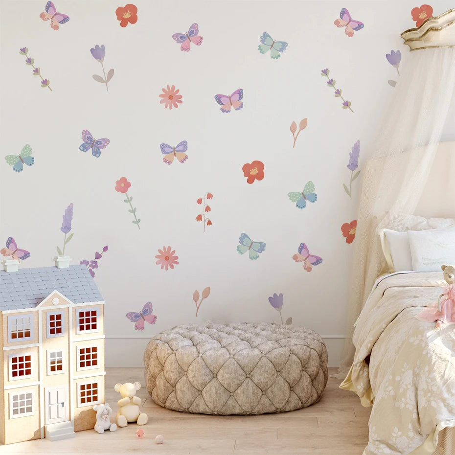 Children's room with butterfly and flower wall decals, a dollhouse, and soft furnishings.