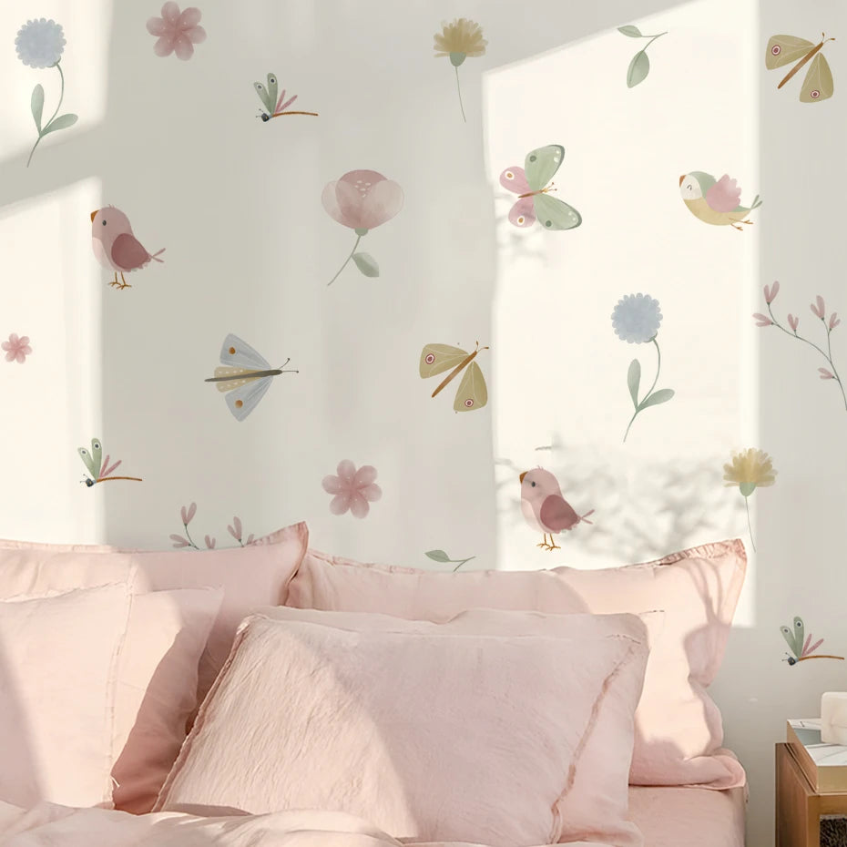 Children's room with floral and bird wall decals on a light pink wall.