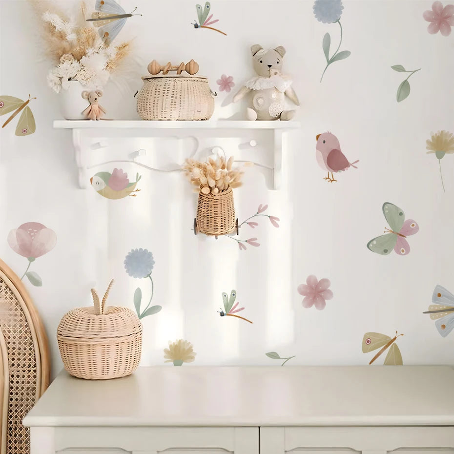 Children's room with shelves, toys, and decorative elements on a wall with floral and butterfly decals.