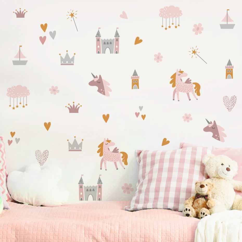 Children's room with pink bedding, teddy bear, and decorative wall stickers of unicorns, castles, and hearts.