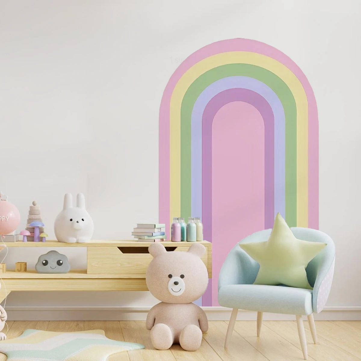 Children's room with a rainbow wall mural, teddy bear, and colorful decor.
