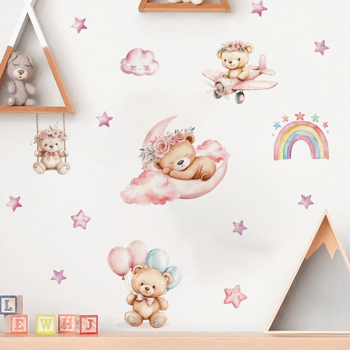 Wall stickers with teddy bears, clouds, and rainbow in a child's room.