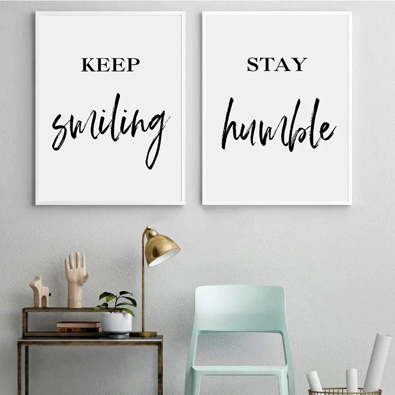 Two motivational posters on a wall with a lamp and chair below.