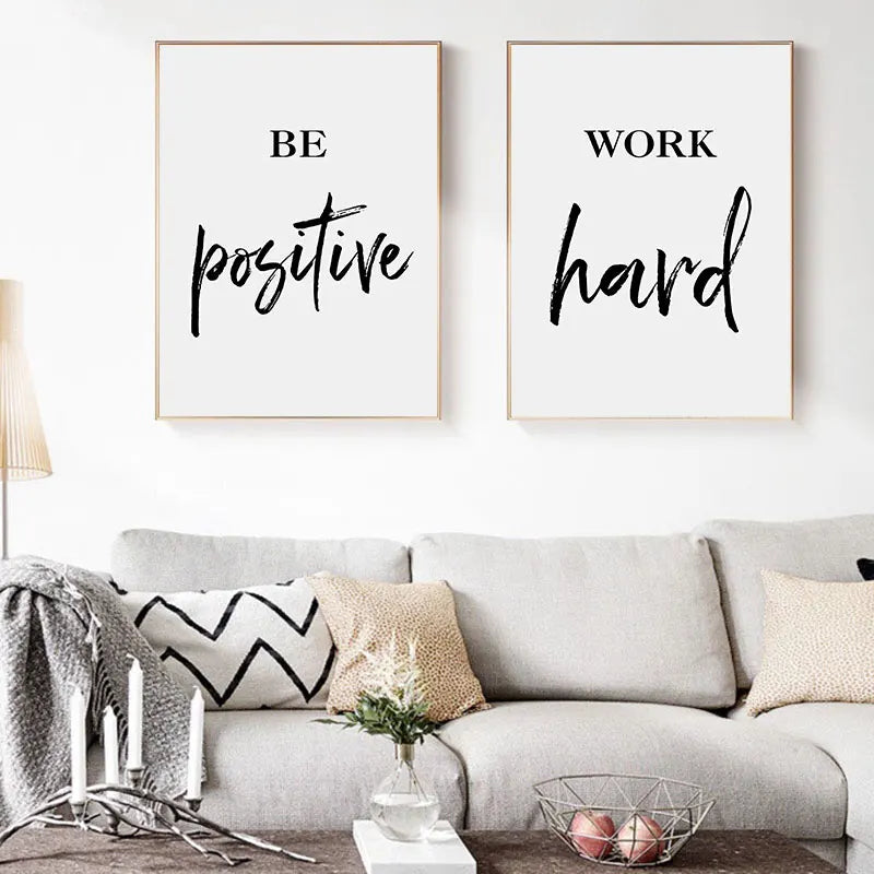 Living room with motivational wall art and a sofa.