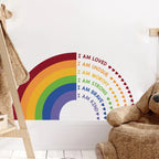 Wall decal with rainbow and motivational phrases in a child's room.