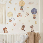 Children's room with wall decals of hot air balloons, animals, and decorative elements.