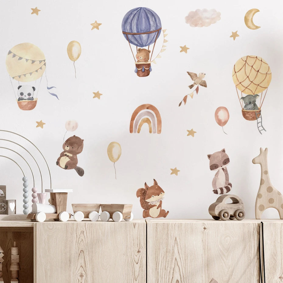Children's room with wall stickers of hot air balloons, animals, and rainbow on a white wall.