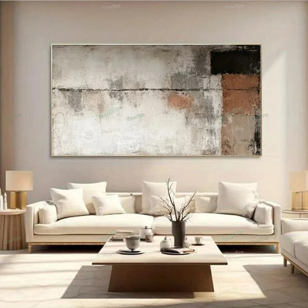 Modern living room with a white sofa, abstract painting, and decorative items.