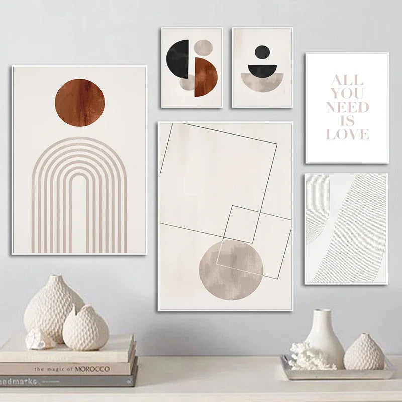 Wall with framed abstract art pieces and decorative vases on a shelf.