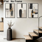 Three framed abstract wall art prints with black, white, gray, and beige brushstrokes displayed on a light wall above a staircase. 