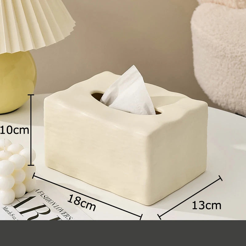 Beige tissue box with dimensions labeled on a surface