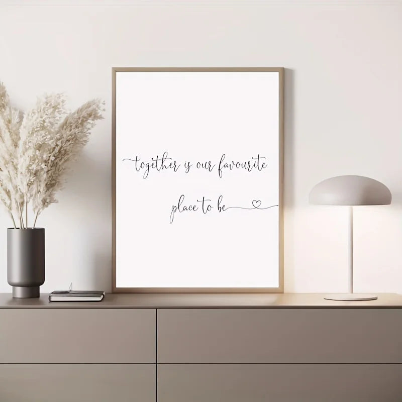 Framed artwork with 'together is our favourite place to be' text on a wall above a cabinet.