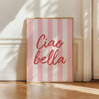 Framed artwork with 'Ciao bella' text on a pink and white striped background