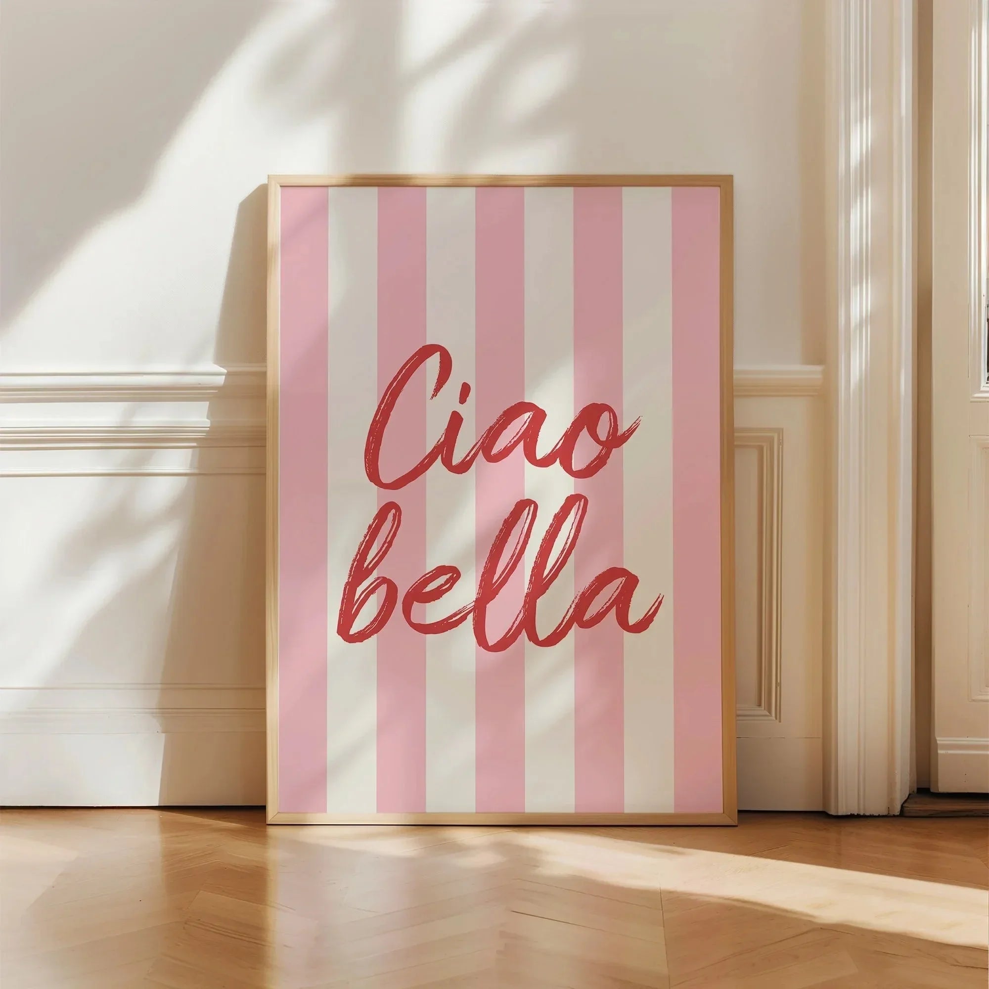 Framed artwork with 'Ciao bella' text on a pink and white striped background
