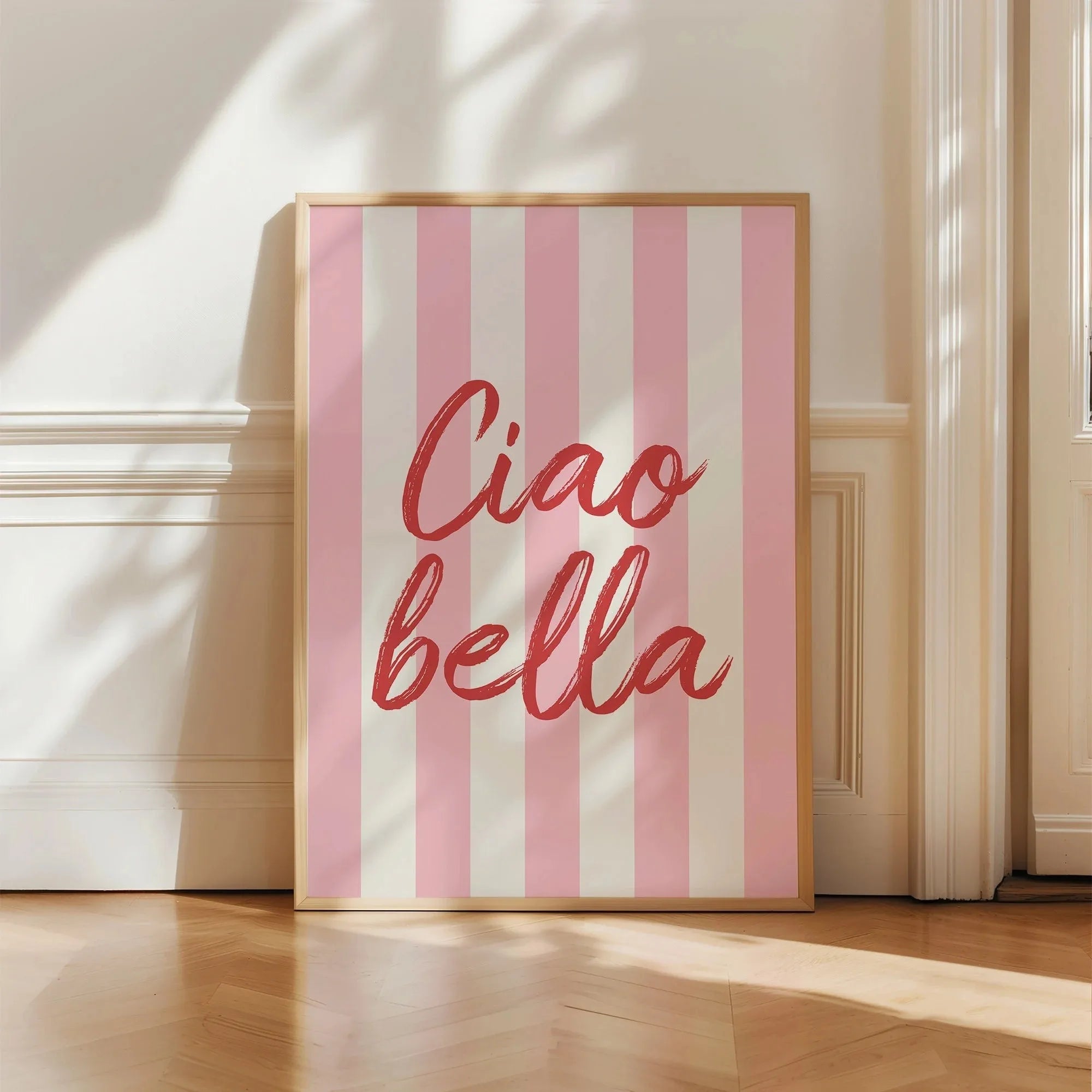 Framed artwork with 'Ciao bella' text on a pink and white striped background