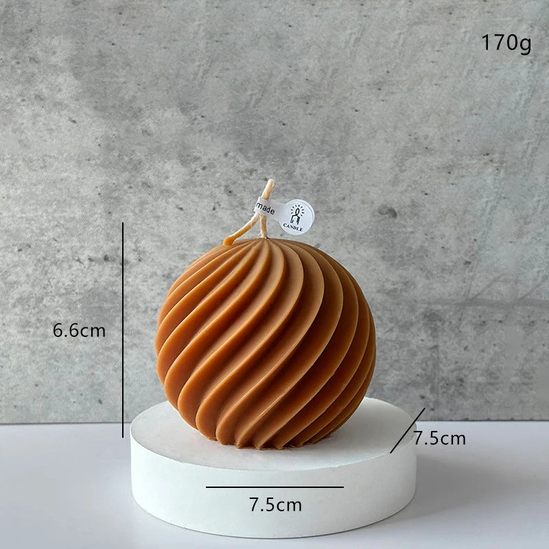 Brown spherical candle with measurements and weight on a gray background