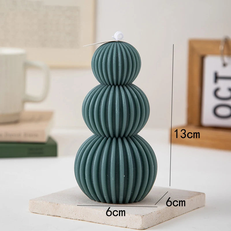 Green textured vase on a white surface with measurements indicated