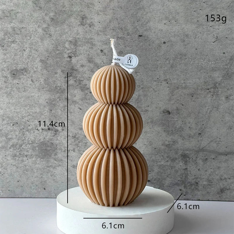 Stacked wooden ornament with measurements and weight on a gray background