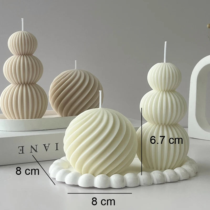 Decorative candles with ribbed texture on a white surface, showing measurements.